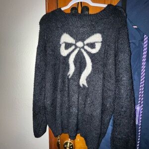 Elegant Black Sweater with White Bow Accent